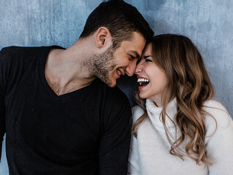 Couple smiling together after dental treatment
